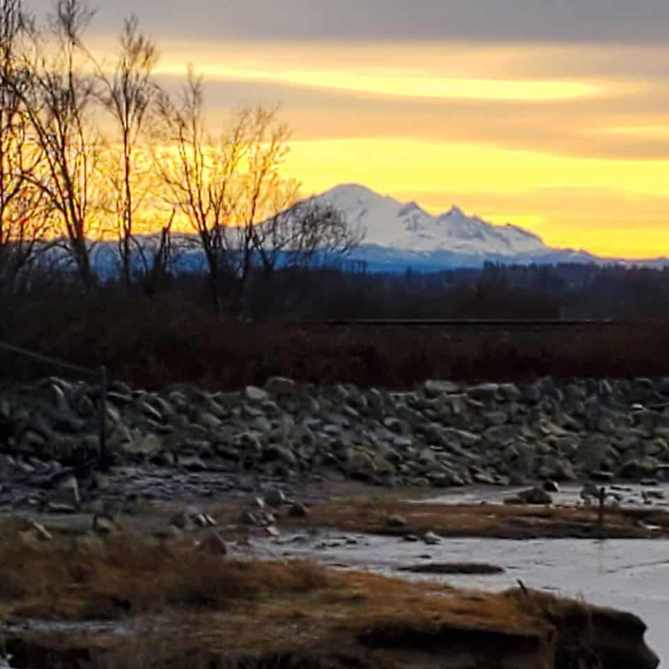 Sunrise with Mount Baker in the distance as seen from the coastline at Mud Bay.
